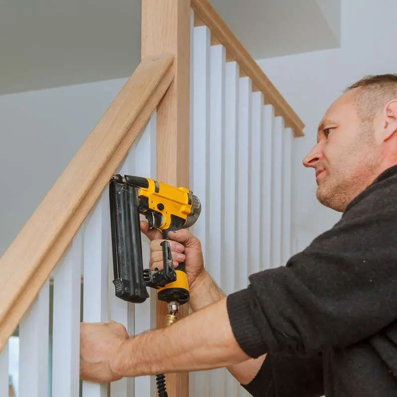 A staircase carpenter doing a handle staircase repair service in Jersey.
