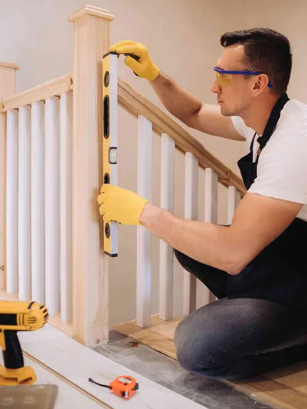 An expert staircase carpenter doing an emergency staircase repair in a Jersey home.